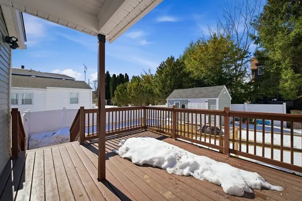 a view of balcony with wooden floor and fence