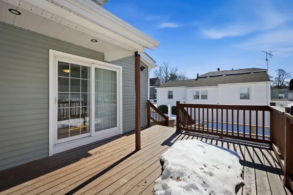 a view of a balcony with wooden floor and fence