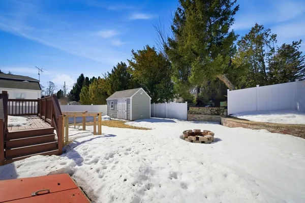 a view of a house with a yard and tree s