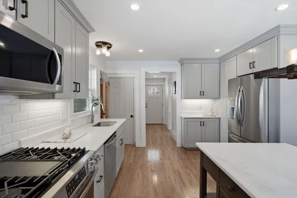 a kitchen with a sink stainless steel appliances and cabinets