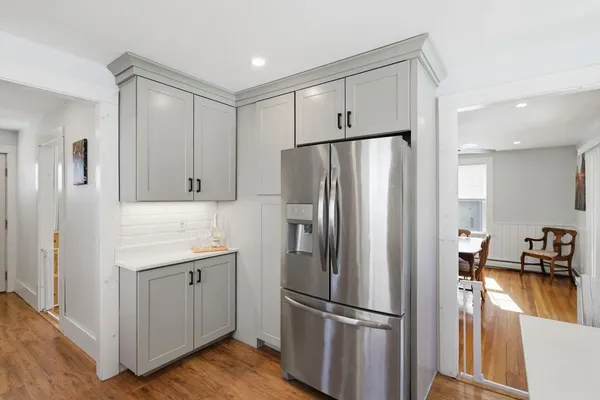 a kitchen with stainless steel appliances a refrigerator sink and cabinets
