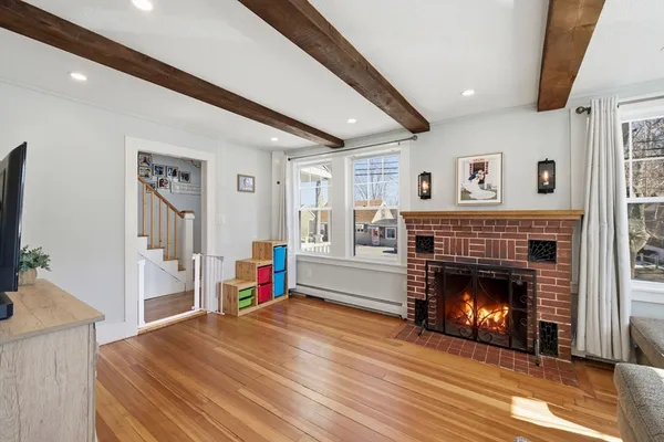 a living room with a fireplace and a flat screen tv