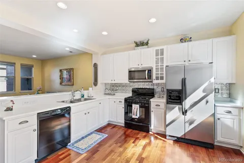 a kitchen with stainless steel appliances sink stove microwave and cabinets