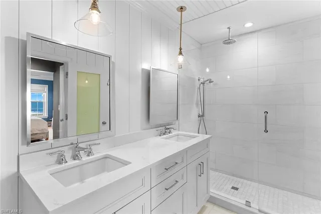 a bathroom with double vanity sinks and a mirror
