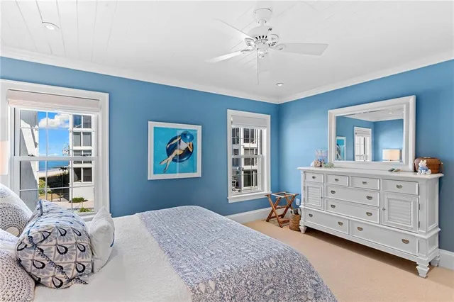 a bedroom with a baby bed and dresser