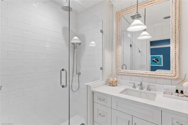 a bathroom with a double vanity sink mirror and shower