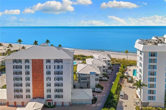 a aerial view of a building with an outdoor space and seating