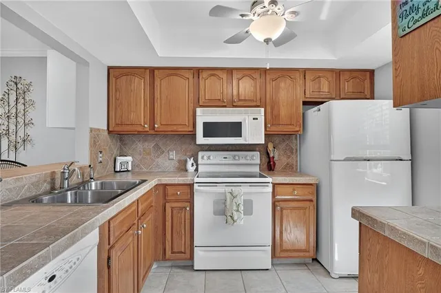 a kitchen with a sink stove and refrigerator