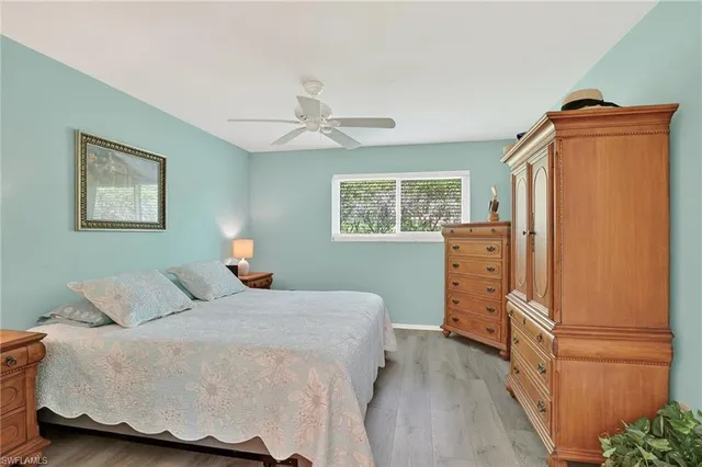 a bedroom with a bed dresser and a window