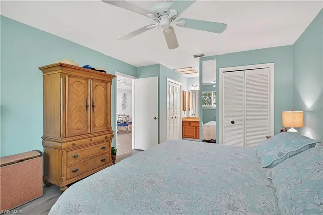 a bedroom with a dresser and a chandelier