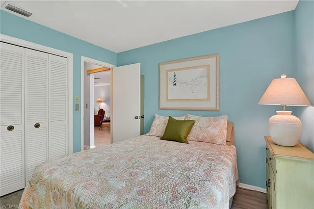 a bedroom with a bed and a lamp