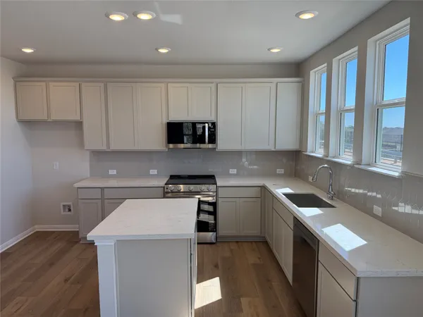 a kitchen that has a sink and a stove in it