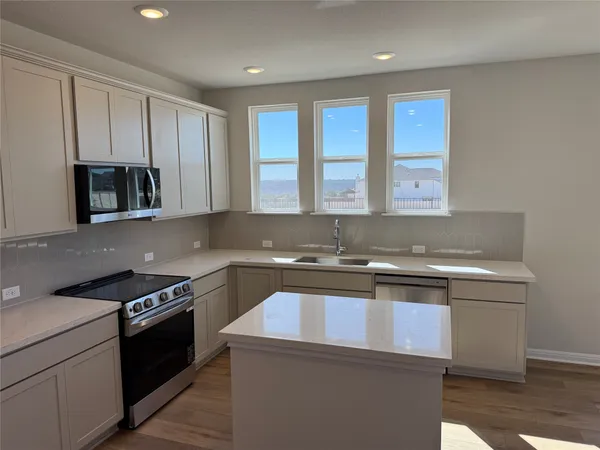a kitchen with a stove and a sink