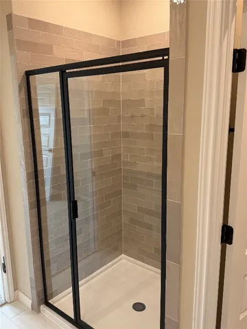 a bathroom with a glass shower door