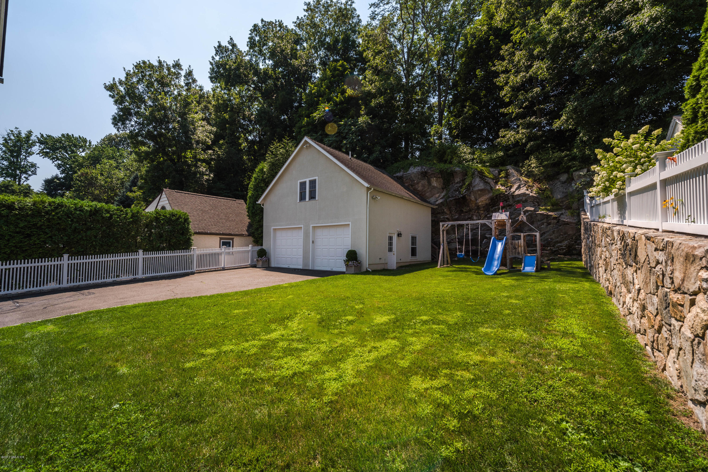 76 Valleywood Road Cos Cob, CT 06830 - Photo 23 of 24 a front view of house with yard and green space