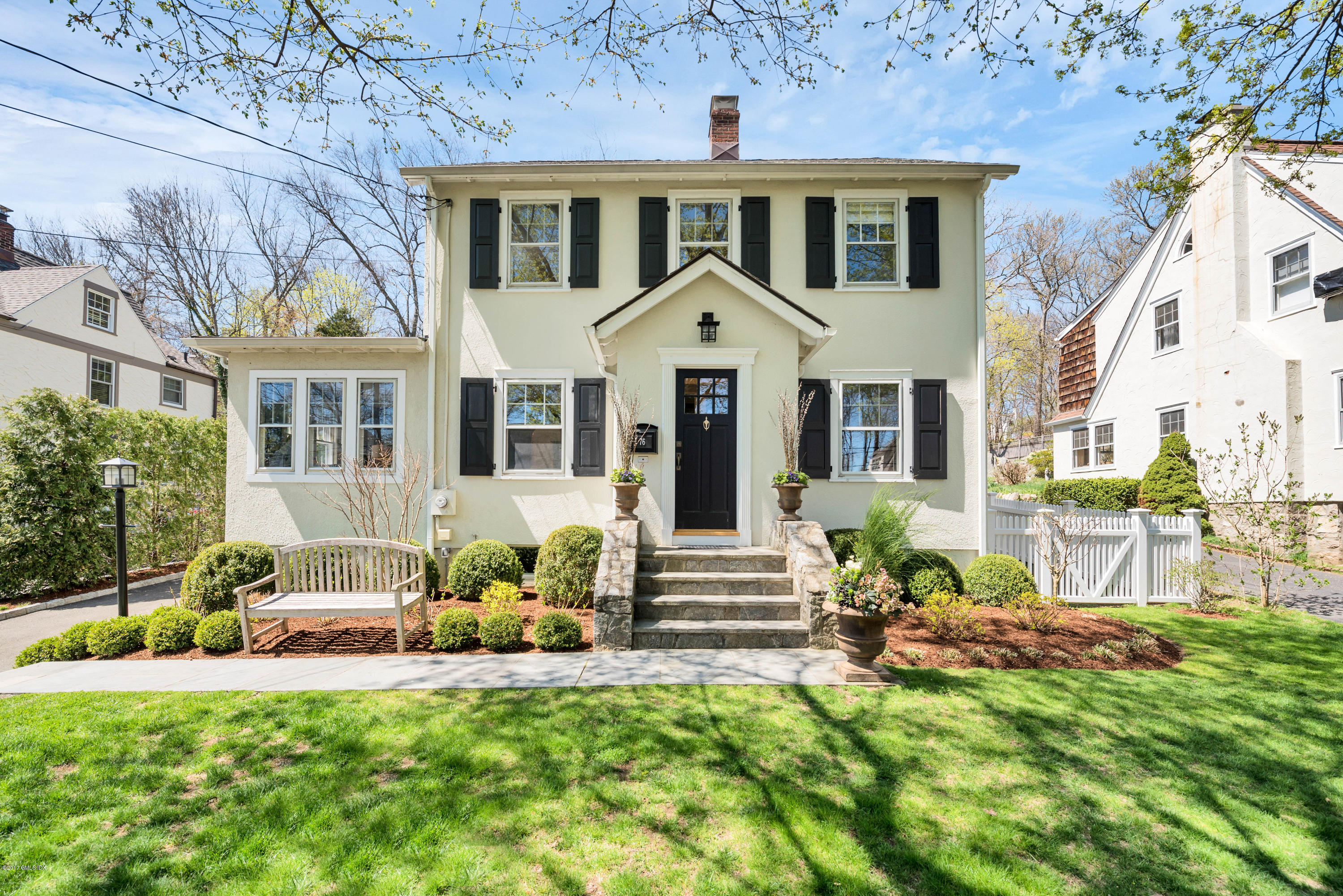 76 Valleywood Road Cos Cob, CT 06830 - Photo 24 of 24 a front view of a house with a garden and porch