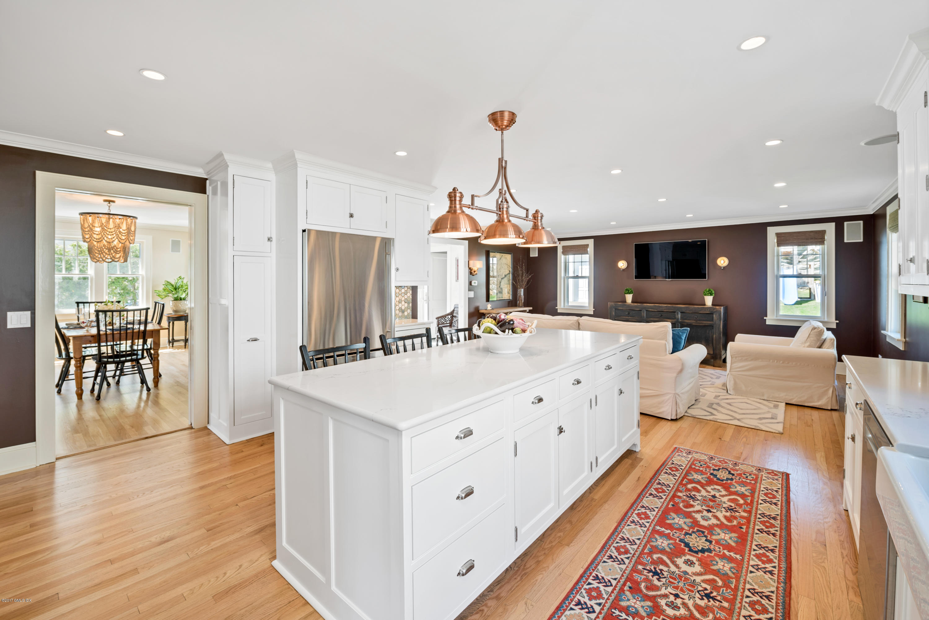 76 Valleywood Road Cos Cob, CT 06830 - Photo 7 of 24 a large white kitchen with a stove a sink a refrigerator and a dining table with wooden floor
