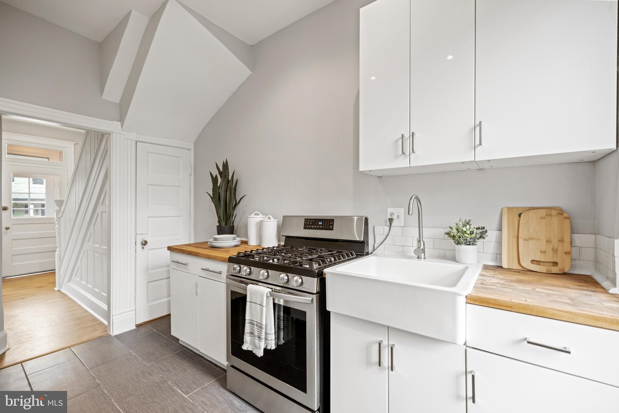 2219 Flagler Place Northwest Washington, DC 20001 - Photo 11 of 31 a kitchen with stainless steel appliances granite countertop a stove a sink and a white cabinets