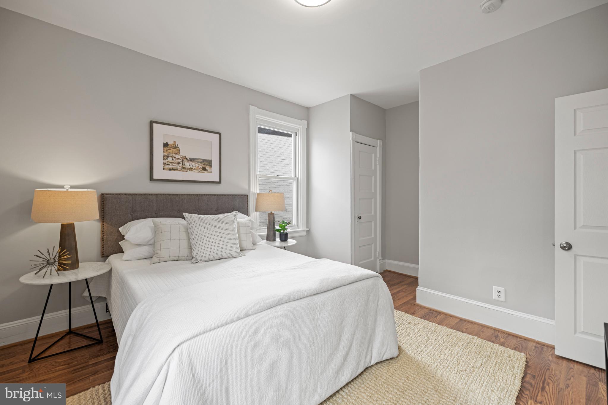 2219 Flagler Place Northwest Washington, DC 20001 - Photo 15 of 31 a bedroom with a bed and a lamp