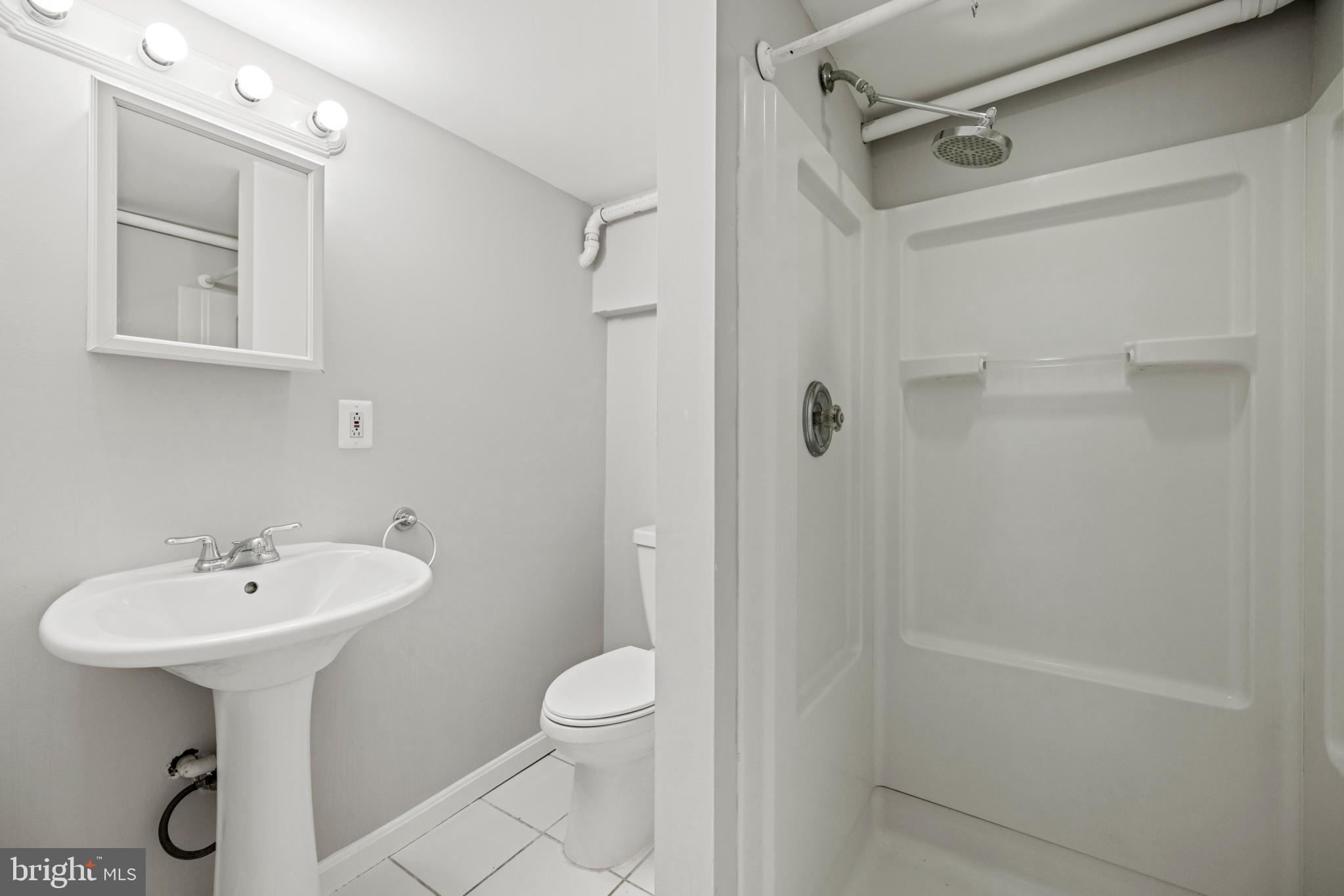 2219 Flagler Place Northwest Washington, DC 20001 - Photo 23 of 31 a bathroom with a sink a toilet and shower