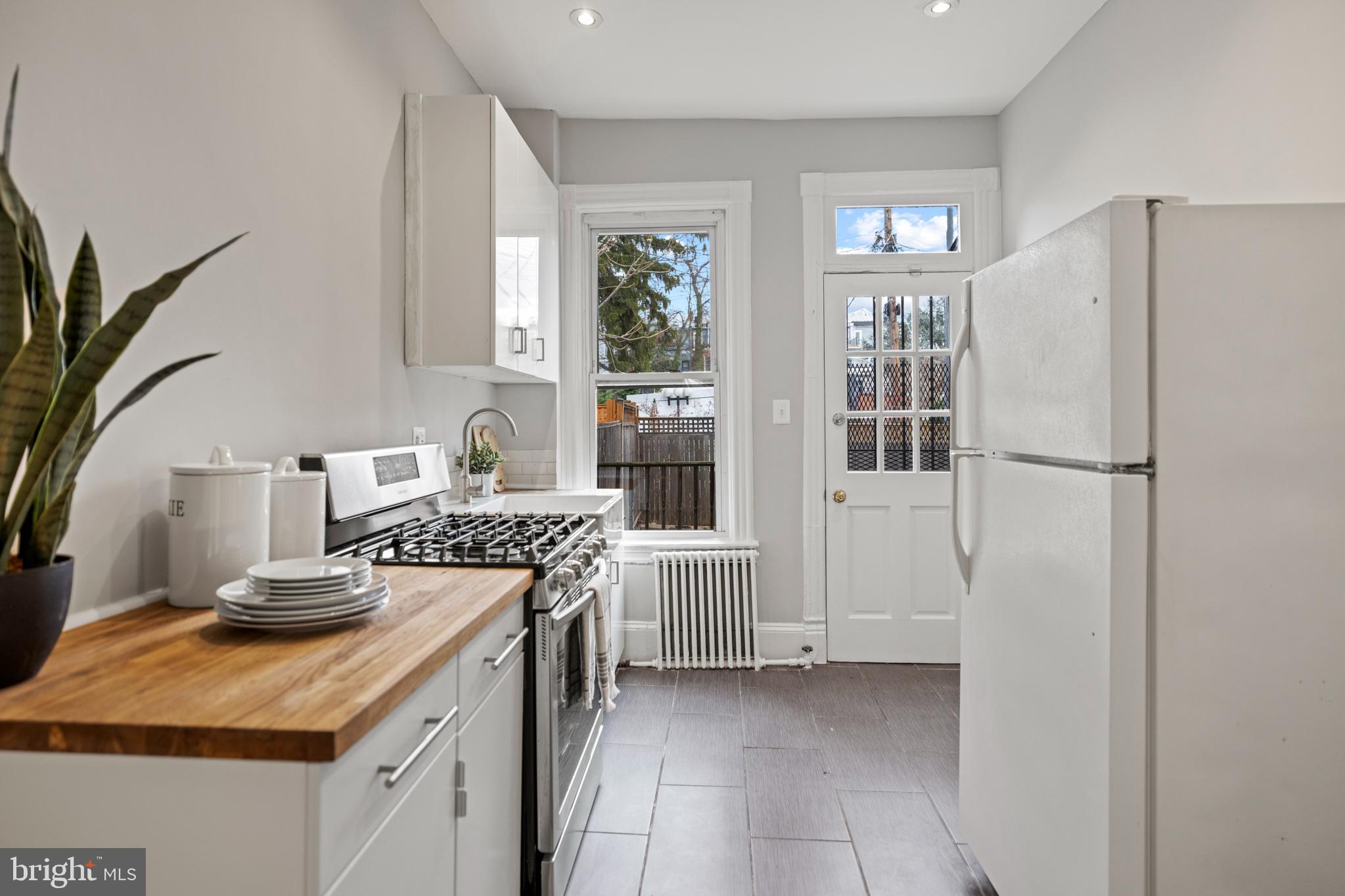 2219 Flagler Place Northwest Washington, DC 20001 - Photo 10 of 31 a kitchen with stainless steel appliances granite countertop a refrigerator and a stove