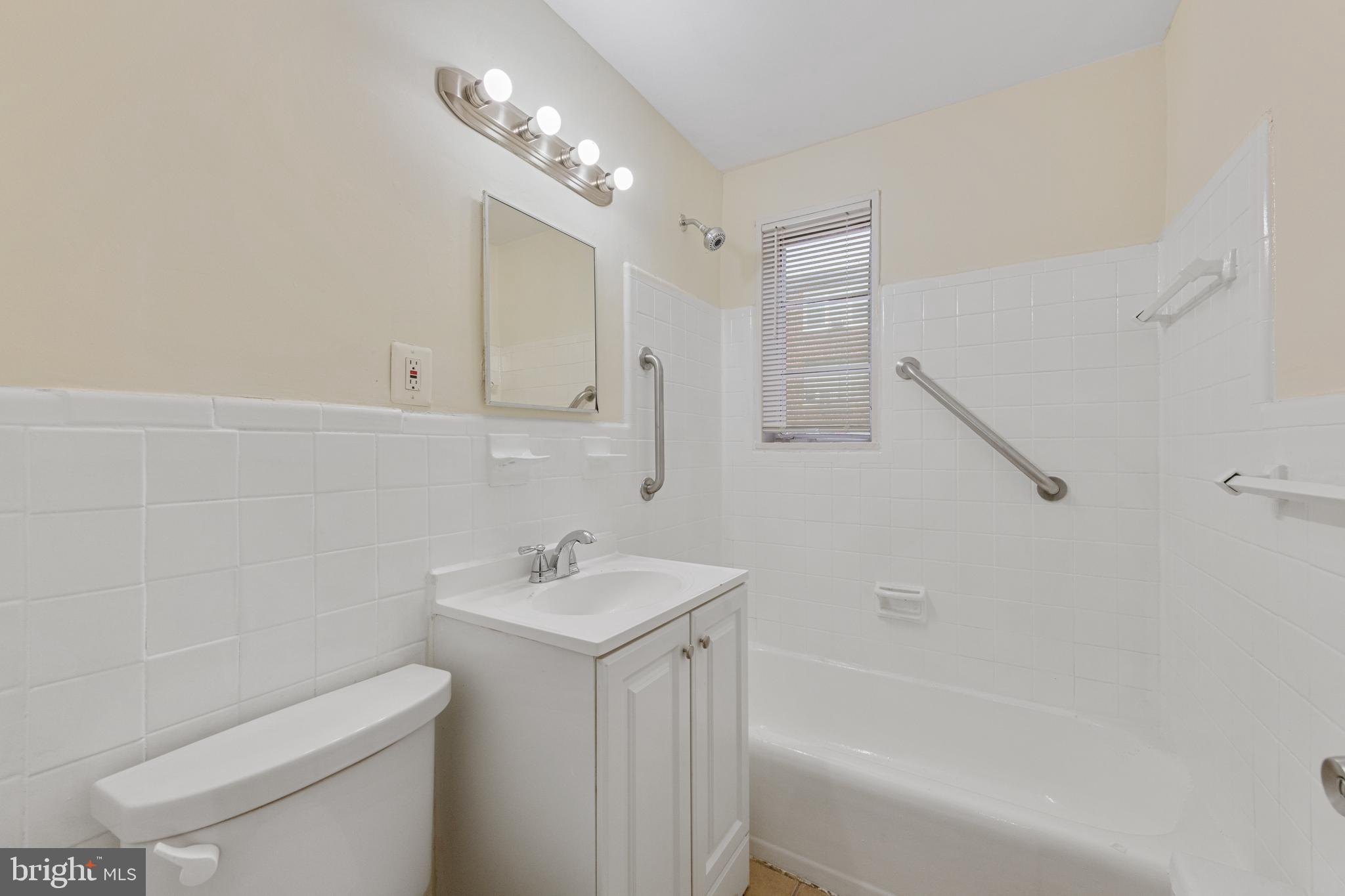 2400 Good Hope Road Southeast, Unit 103 Washington, DC 20020 - Photo 12 of 14 a bathroom with a sink a toilet and shower