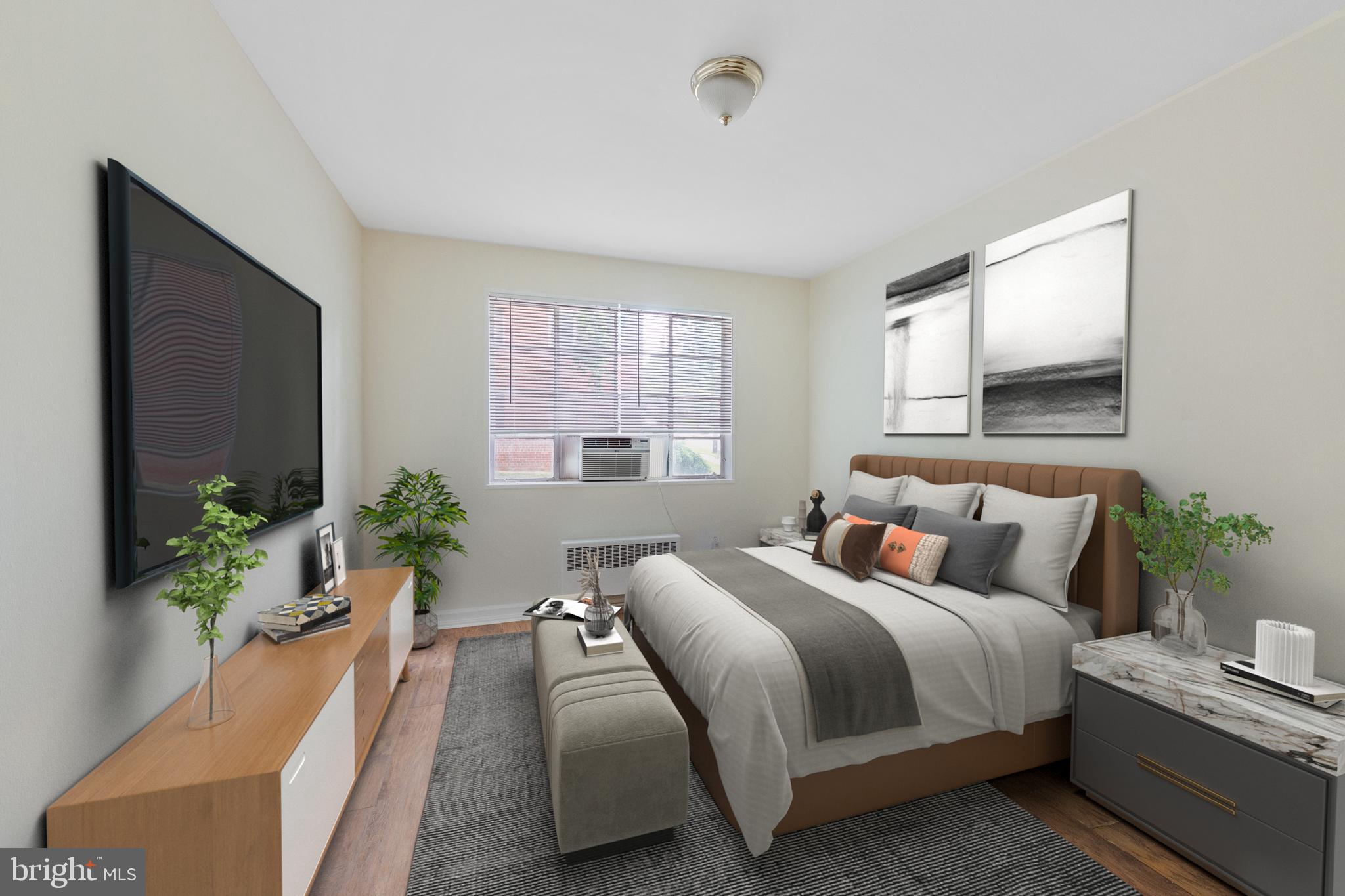 2400 Good Hope Road Southeast, Unit 103 Washington, DC 20020 - Photo 13 of 14 a bedroom with a bed and a potted plant