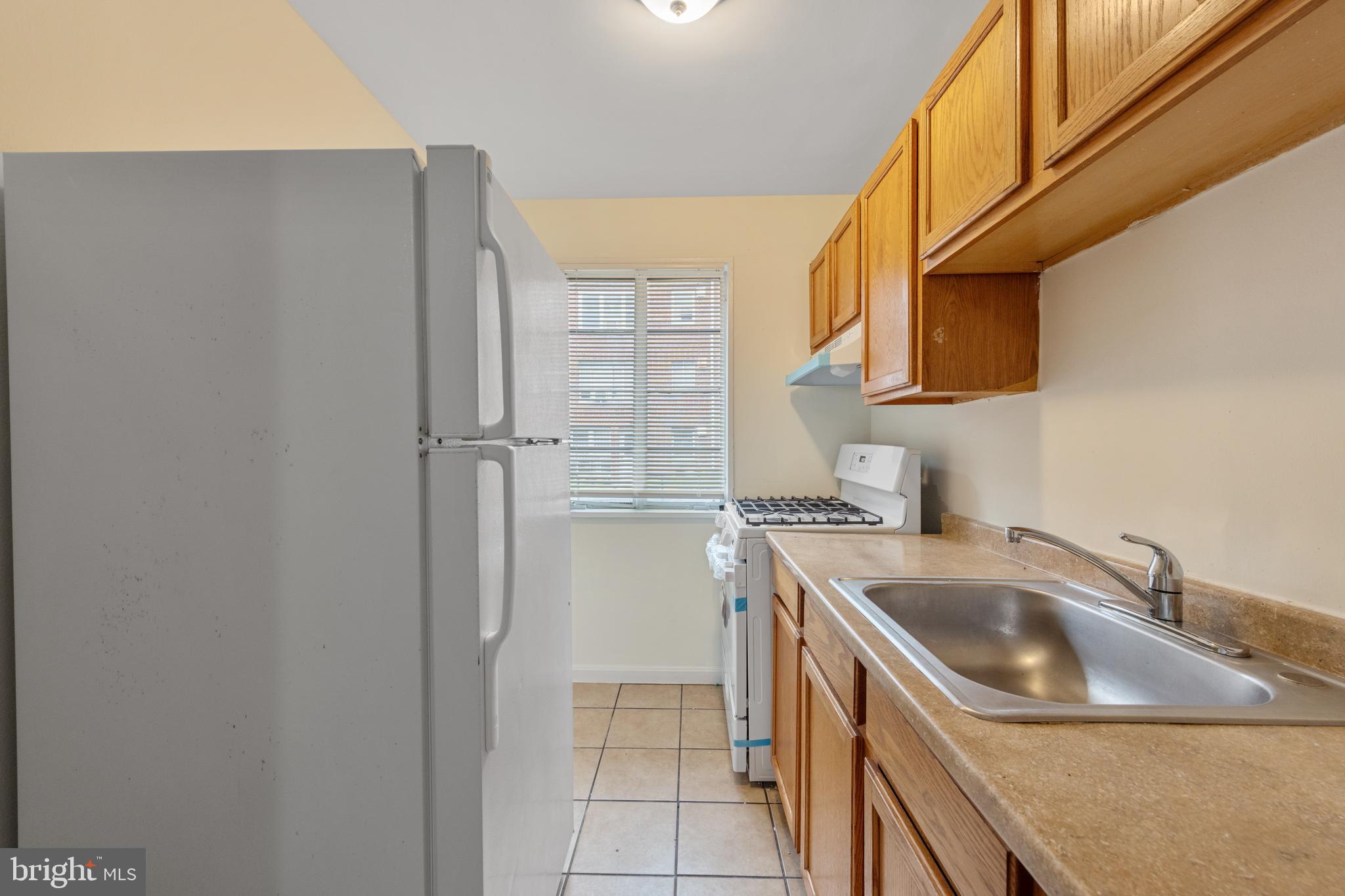 2400 Good Hope Road Southeast, Unit 103 Washington, DC 20020 - Photo 9 of 14 a kitchen with a sink and refrigerator