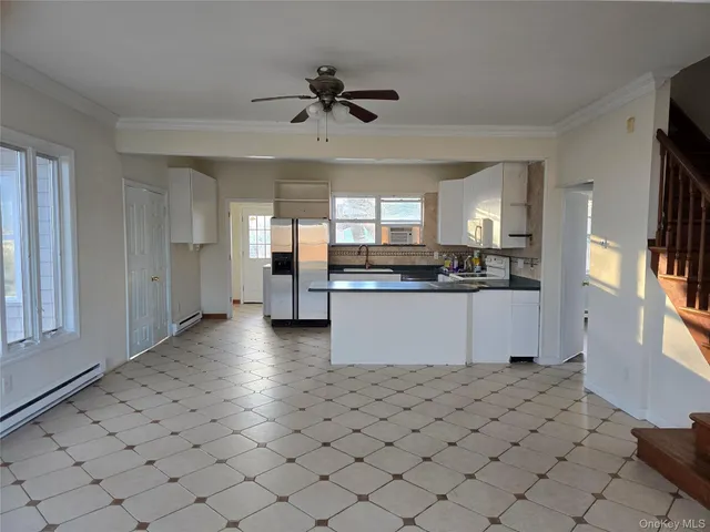a kitchen with granite countertop white cabinets and stainless steel appliances