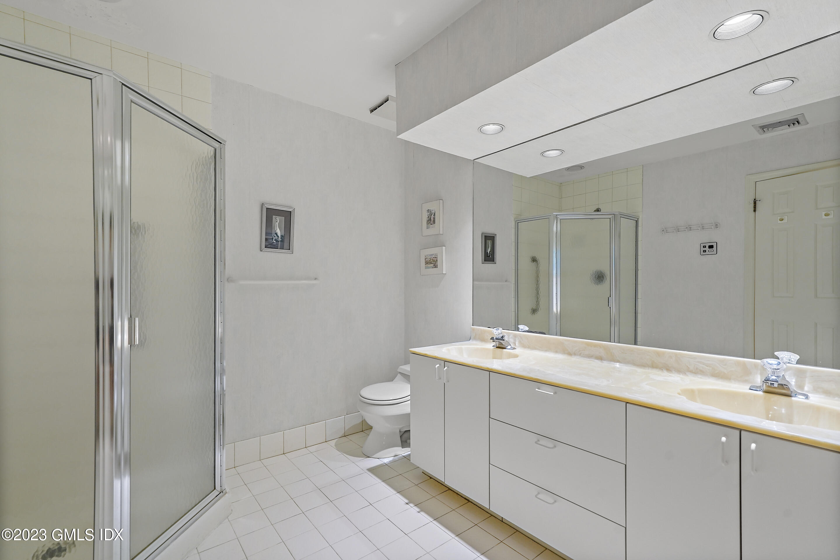 500 River Road, Unit 12 Cos Cob, CT 06807 - Photo 22 of 30 a spacious bathroom with a double vanity sink mirror and toilet