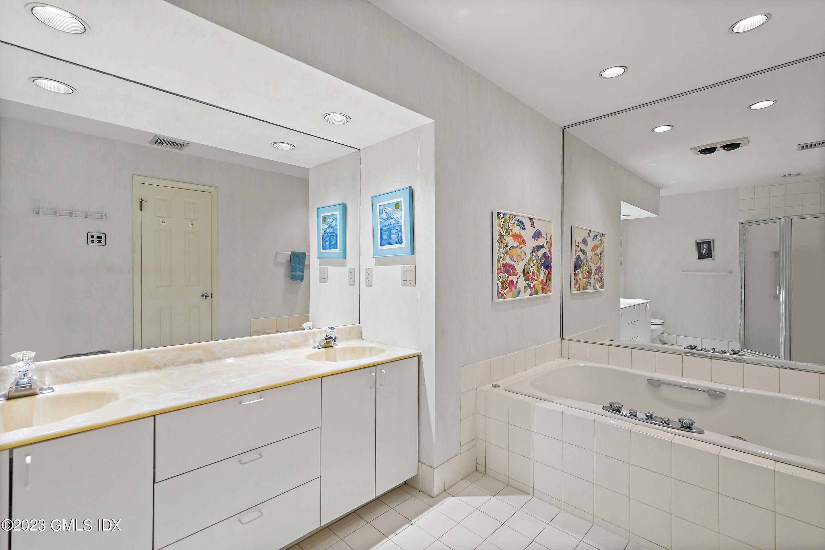 500 River Road, Unit 12 Cos Cob, CT 06807 - Photo 23 of 30 a spacious bathroom with a tub sink and mirror