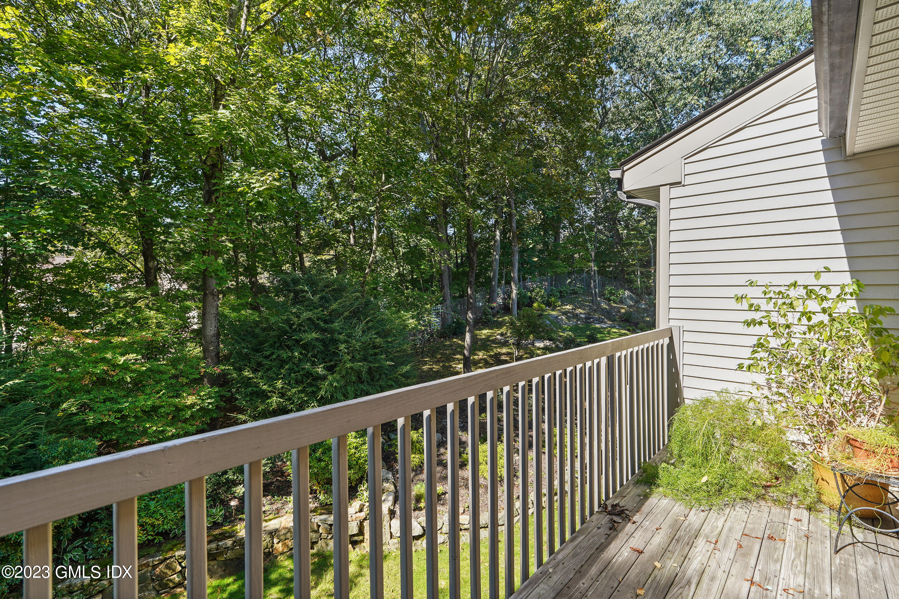 500 River Road, Unit 12 Cos Cob, CT 06807 - Photo 27 of 30 a balcony with wooden floor and yard in the back