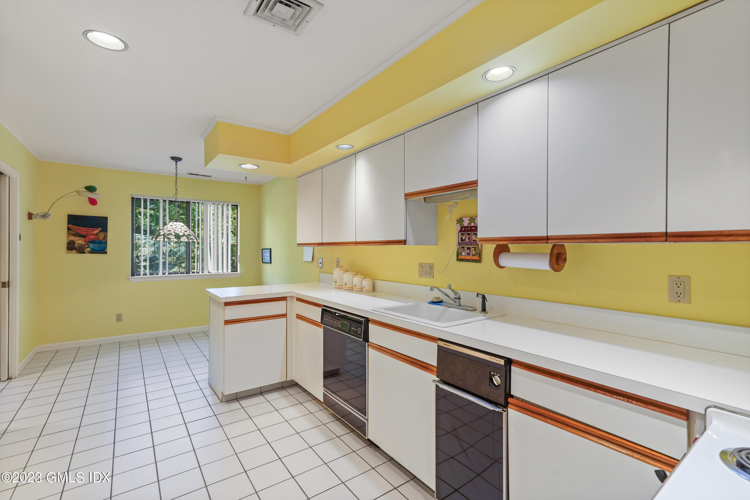 500 River Road, Unit 12 Cos Cob, CT 06807 - Photo 7 of 30 a kitchen with a sink and cabinets