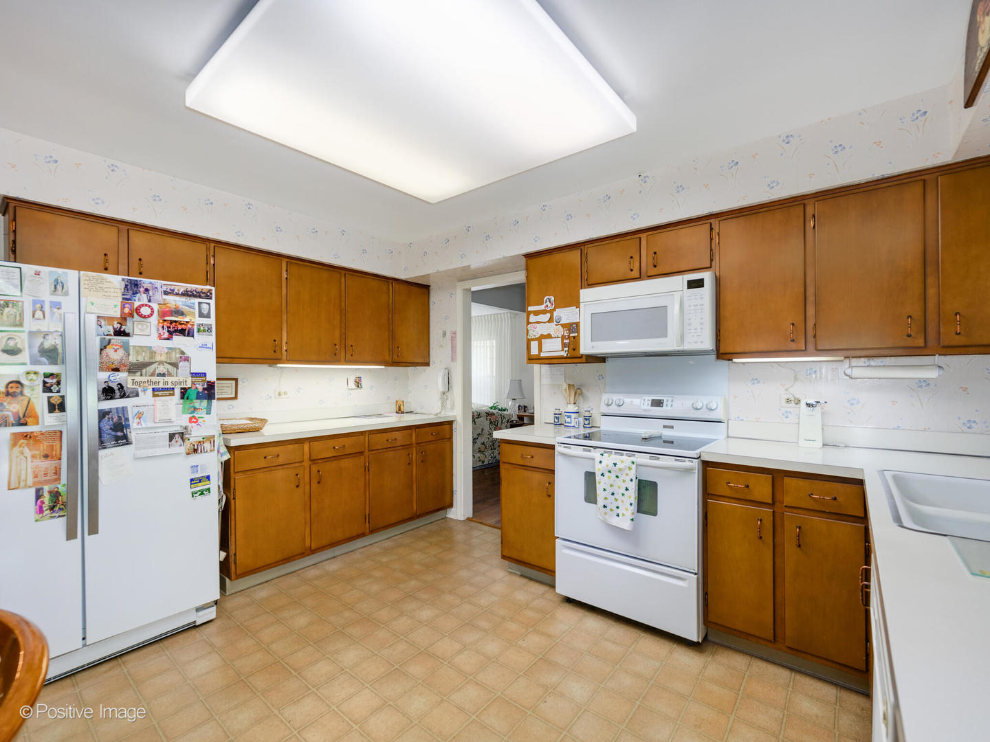 1107 Juniper Terrace Glenview, IL 60025 - Photo 11 of 30 a kitchen with stainless steel appliances a stove a sink and a refrigerator