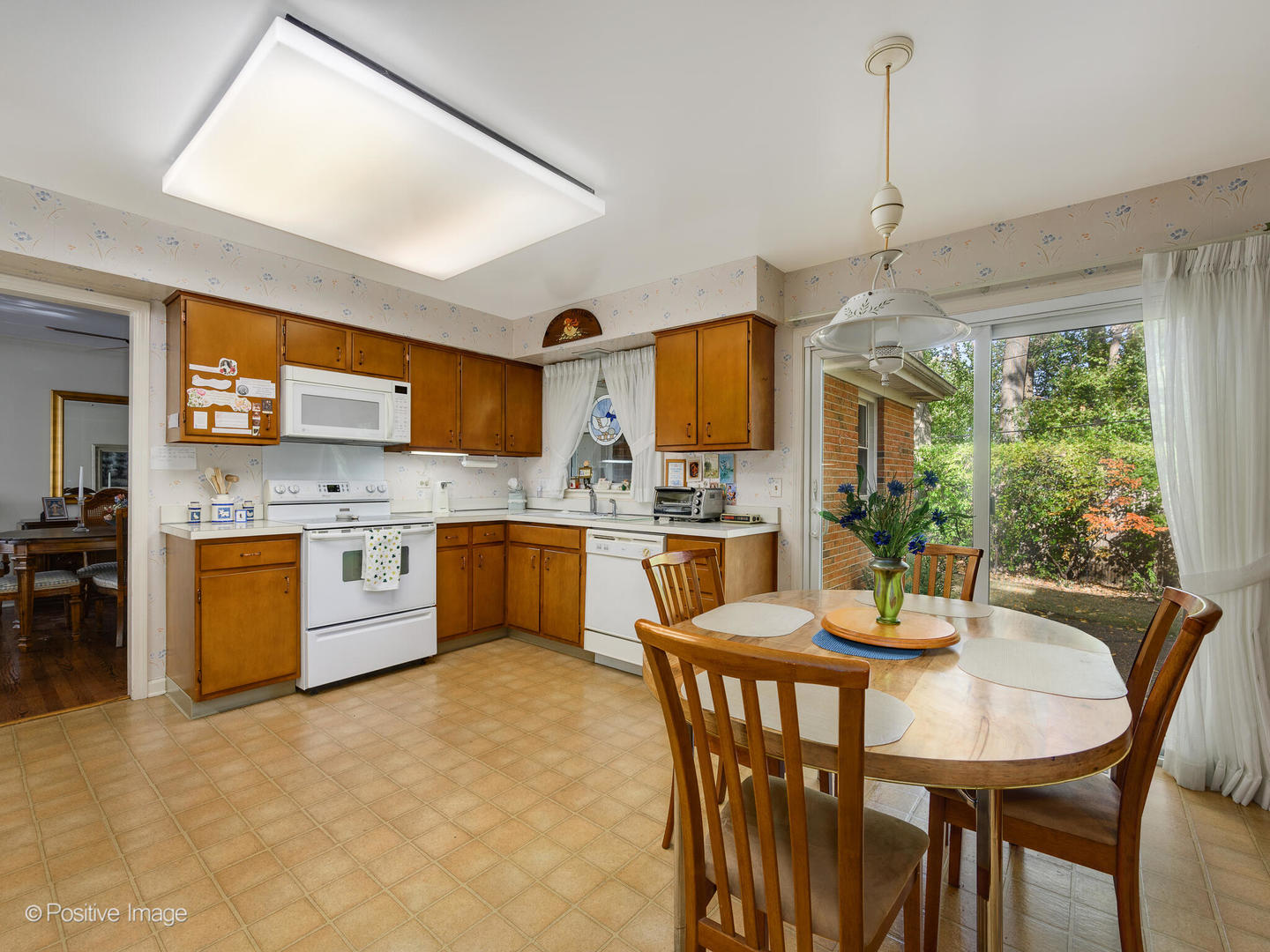 1107 Juniper Terrace Glenview, IL 60025 - Photo 12 of 30 a kitchen with a table chairs microwave and cabinets