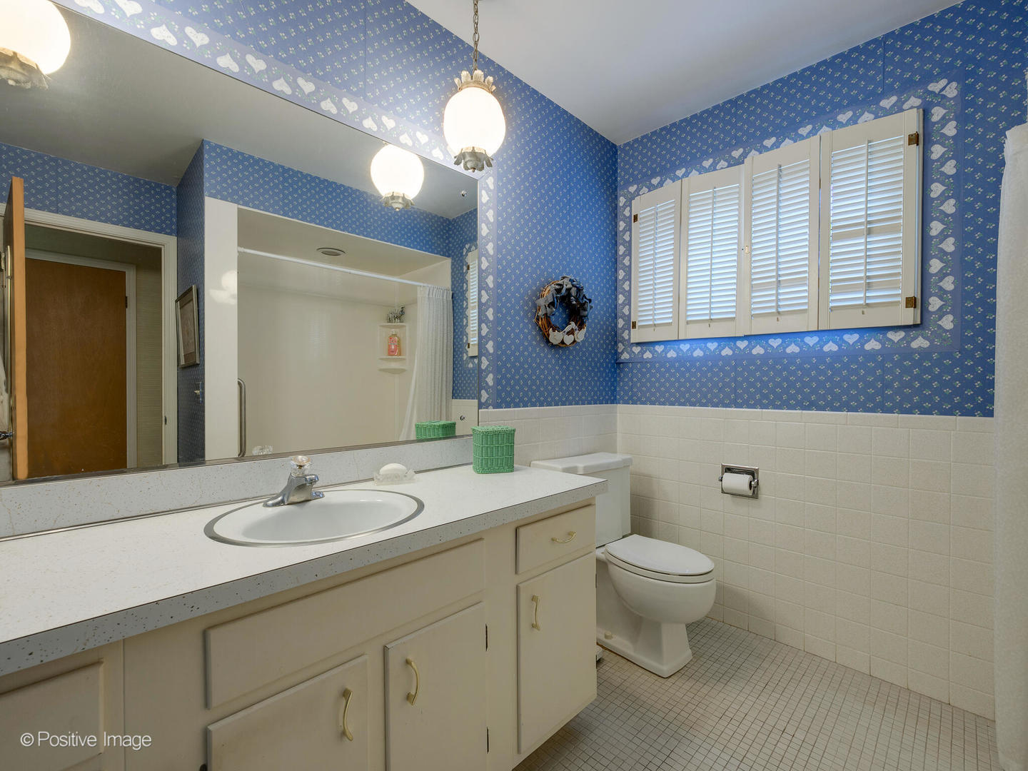 1107 Juniper Terrace Glenview, IL 60025 - Photo 20 of 30 a bathroom with a toilet a sink a mirror and a window