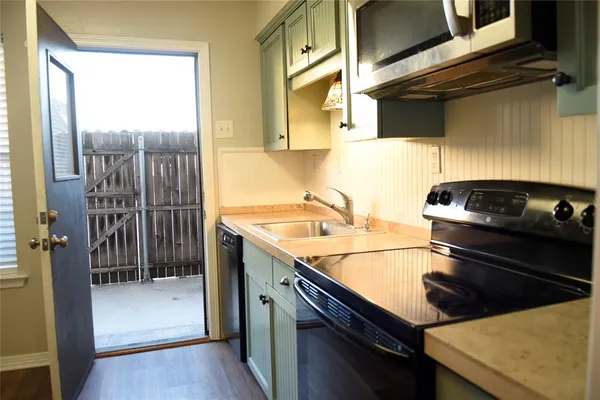 a kitchen with a sink and cabinets