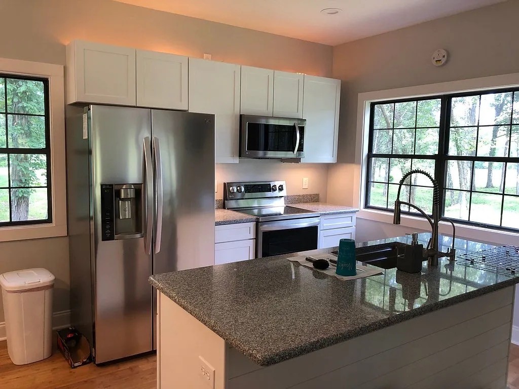 3 Millersburg Road Christiana, TN 37037 - Photo 46 of 60 a kitchen with stainless steel appliances granite countertop a refrigerator a sink a stove and a counter space