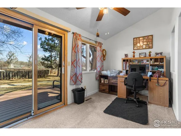 a view of a workspace with furniture and a window