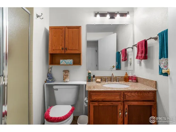 a bathroom with a sink vanity mirror and toilet