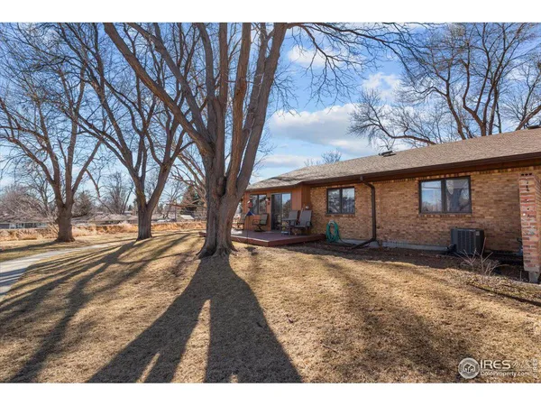 a view of a house with a yard covered in snow