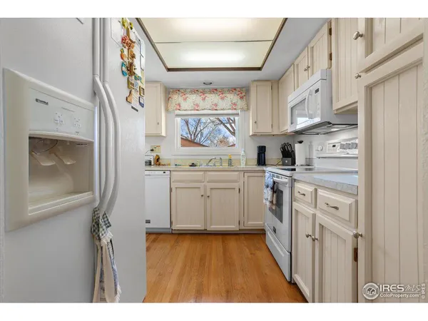 a kitchen with stainless steel appliances a white stove top oven and a refrigerator