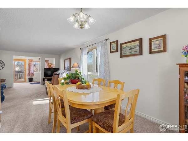 a view of a dining room with furniture and chandelier