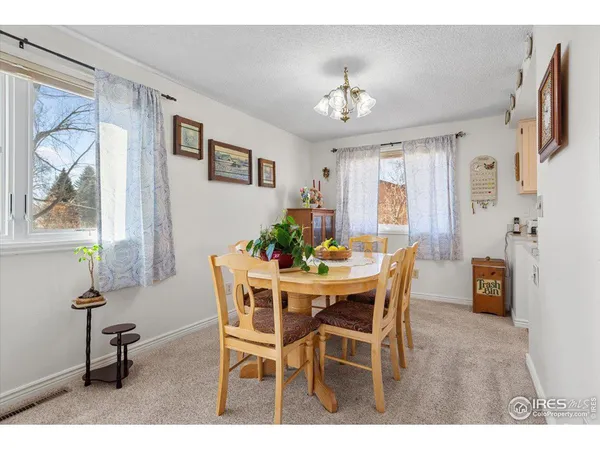 a view of a dining room with furniture and chandelier