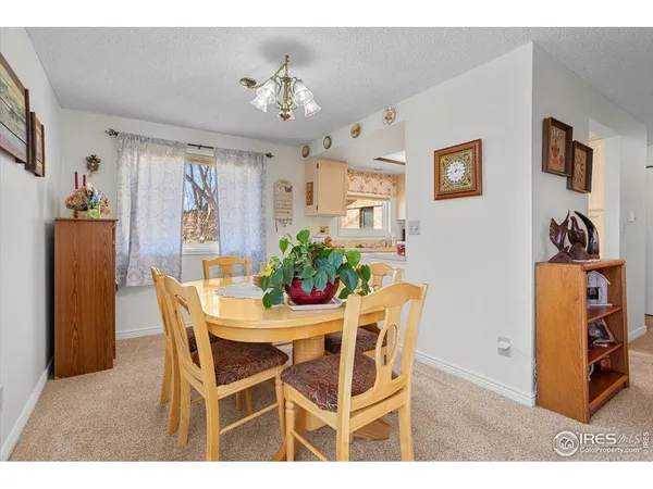 a view of a dining room with furniture and chandelier