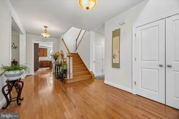a view of entryway with wooden floor and livingroom view