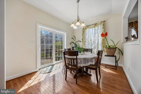 a view of a dining room with furniture wooden floor and chandelier