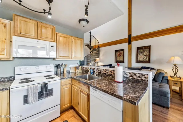 a kitchen with a table chairs and stove