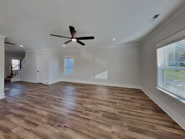 a view of a room with wooden floor and a window