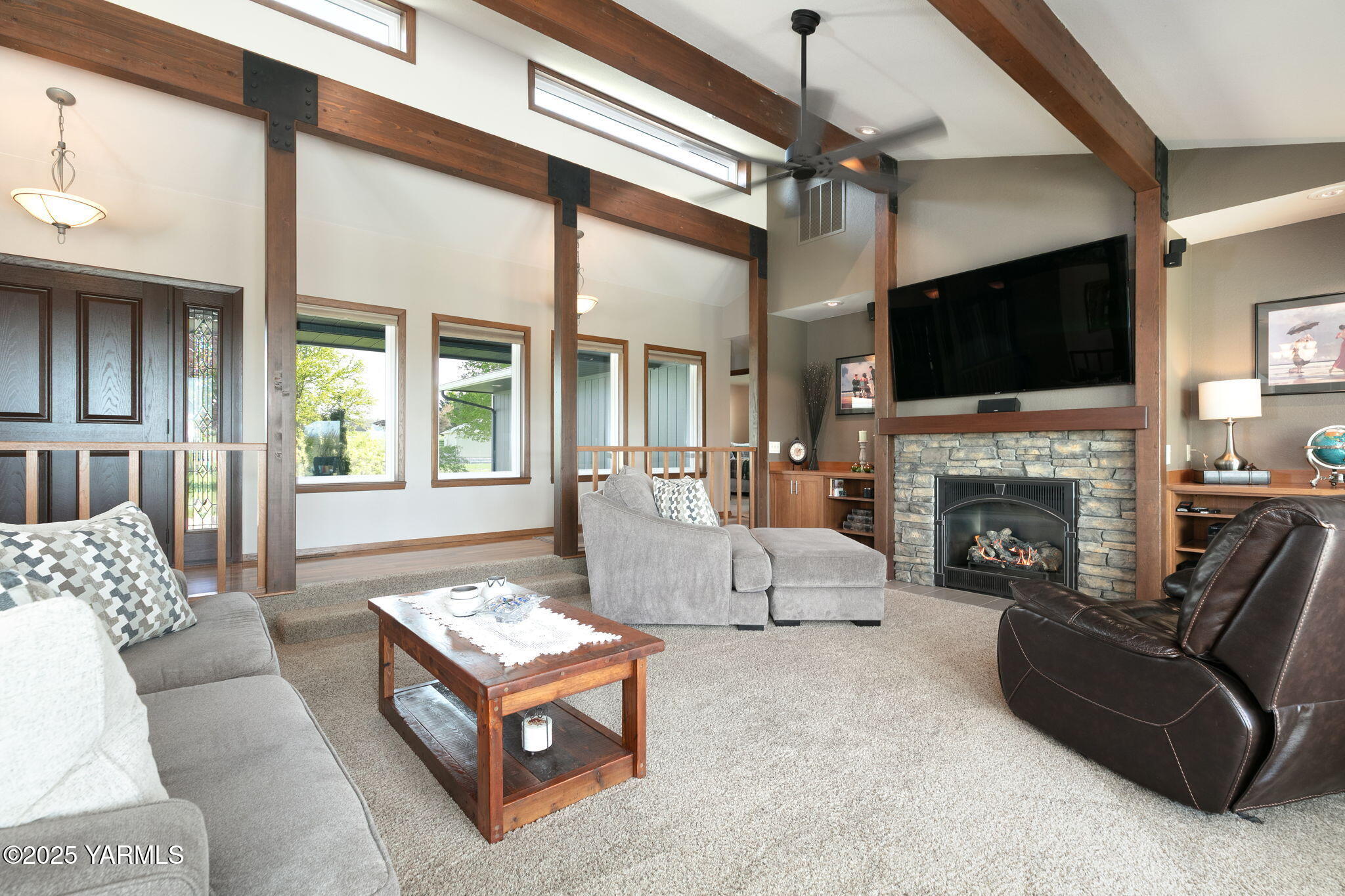 9370 Bittner Road Yakima, WA 98901 - Photo 4 of 38 a living room with furniture a flat screen tv and a fireplace